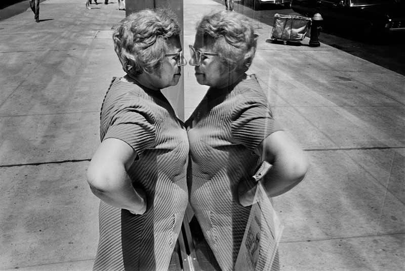 Richard Kalvar 1969. Woman looking at herself in store window